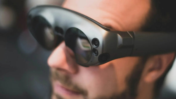 AR glasses with front-facing cameras worn for spatial computing and mixed-reality use.
