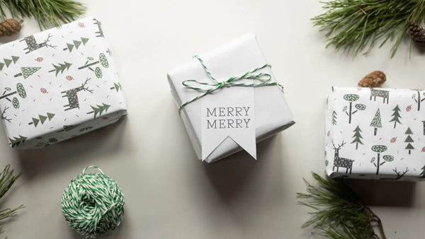 Wrapped Christmas gifts and evergreen branches for a 2026 guide to Christmas gifts for men.