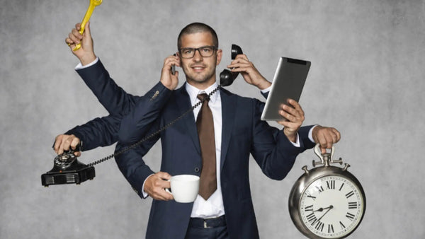 Sales rep juggling calls, a tablet and time pressure to illustrate field-sales workflow friction.