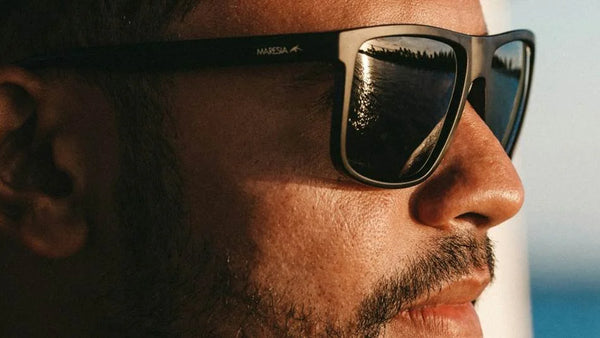 Man wearing black rectangular sunglasses outdoors, representing everyday sunglasses for men in 2026.