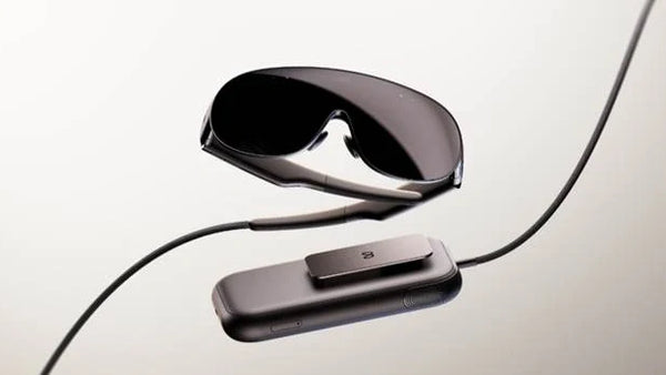 Meta VR Glasses with an external compute puck and tether cable on a light background.