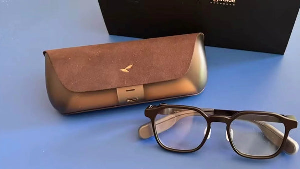 RayNeo iO smart glasses alongside the charging case during hands-on testing.