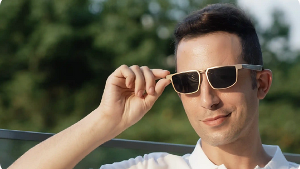 A professional man wearing premium gold-frame smart sunglasses without a camera, featured as a stylish alternative to Ray-Ban Meta in 2026