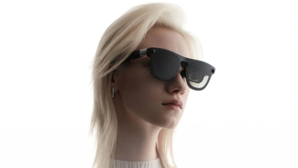 Woman wearing XREAL AURA glasses, highlighting the Android XR smart glasses design.