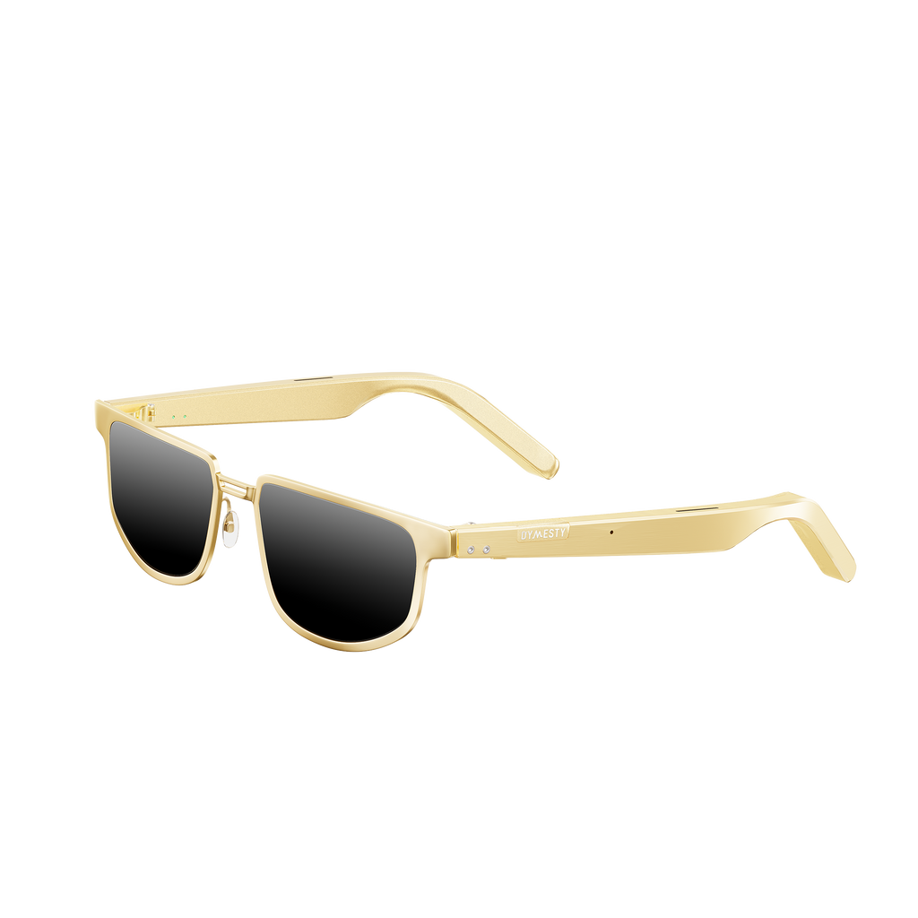 Dymesty Moore Vision AI Smart Sunglasses in champagne gold titanium frame with dark gray lenses, front view on transparent background — 35g lightweight, 48-hour battery, real-time translation in 100 languages, camera-free design