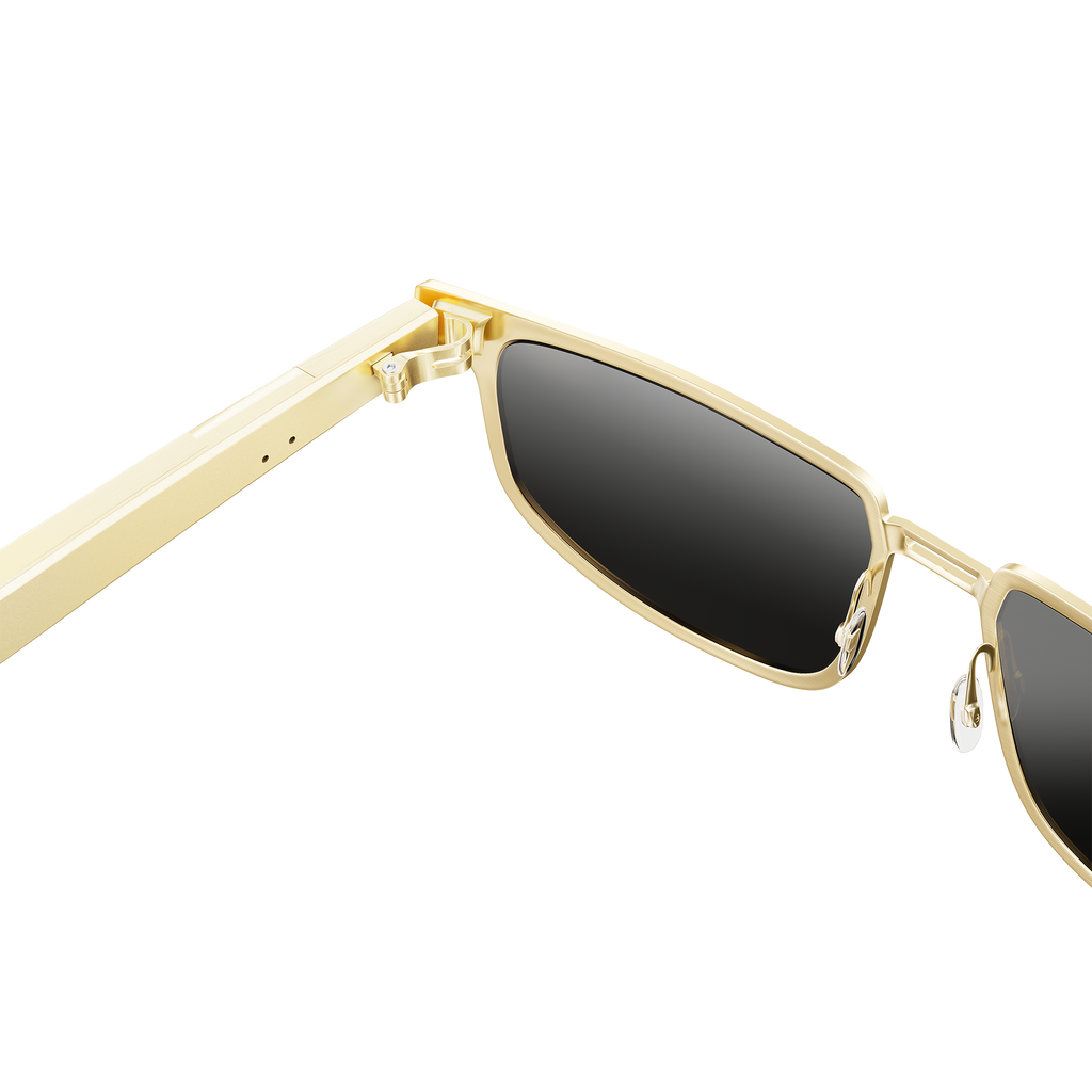 Dymesty Moore Vision AI Smart Sunglasses in champagne gold titanium frame with dark gray lenses, front view on transparent background — 35g lightweight, 48-hour battery, real-time translation in 100 languages, camera-free design