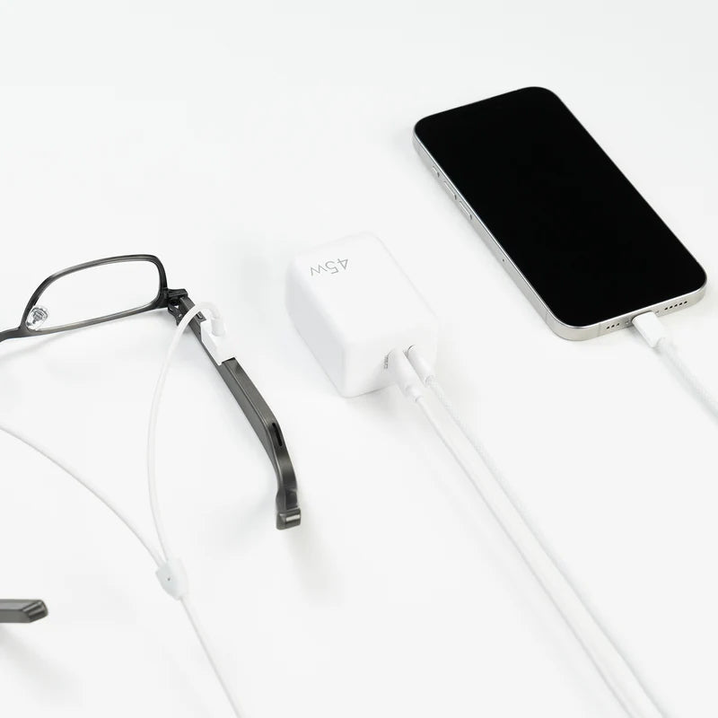 Dymesty Power Adapter charging a smartphone and AI glasses simultaneously. The essential tool for multi-device efficiency.
