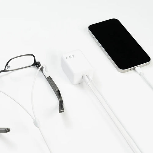 Dymesty Power Adapter charging a smartphone and AI glasses simultaneously. The essential tool for multi-device efficiency.