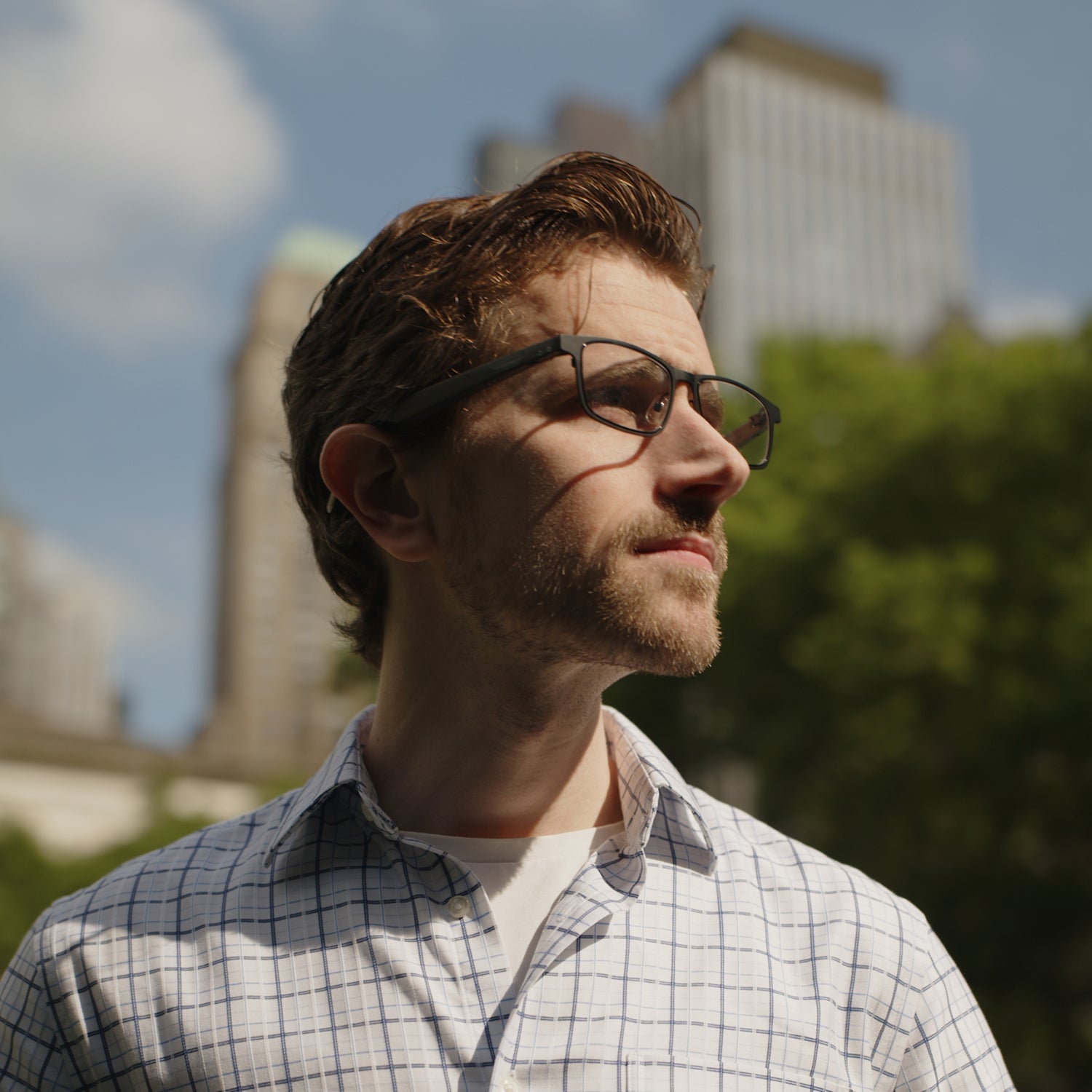 Professional man wearing Dymesty Cook Edge black titanium AI smart glasses outdoors